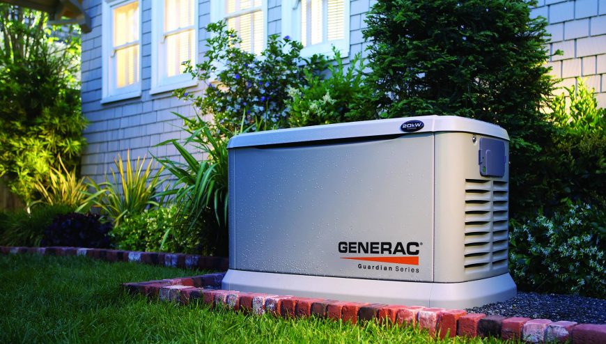 Generac generator outside of home on a brick bed- surrounded by green grass