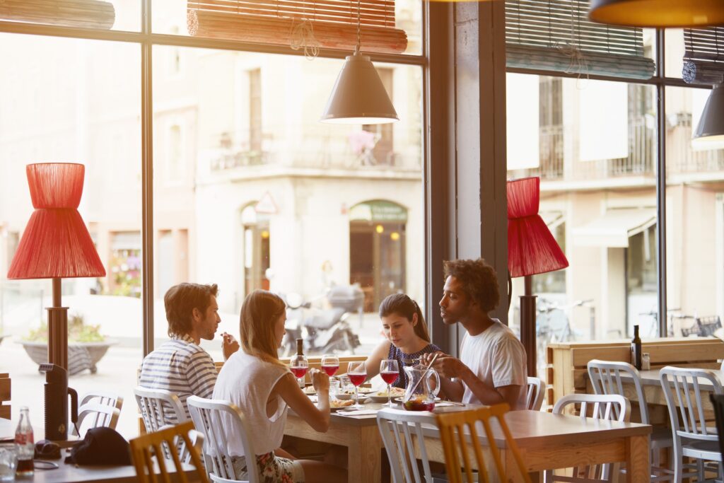 Multi-ethnic friends having lunch in restaurant